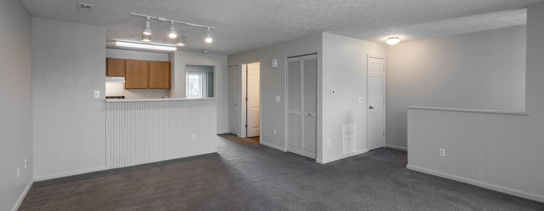 a room with white walls and a carpeted floor